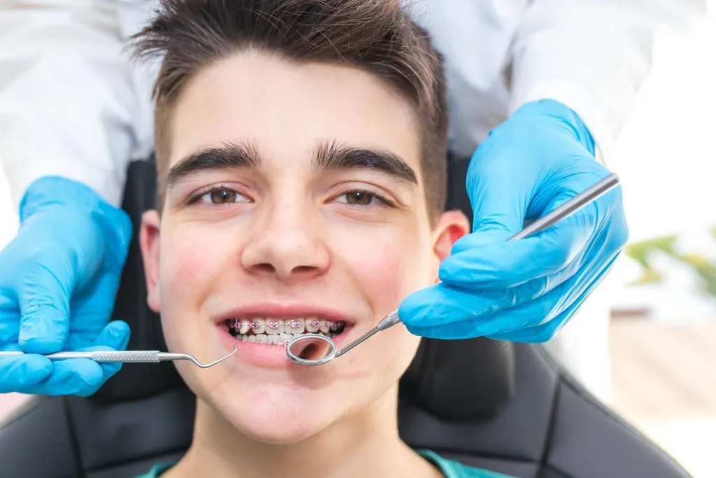 A boy having his braces checked at Dentist In The Park, Bondi Junction