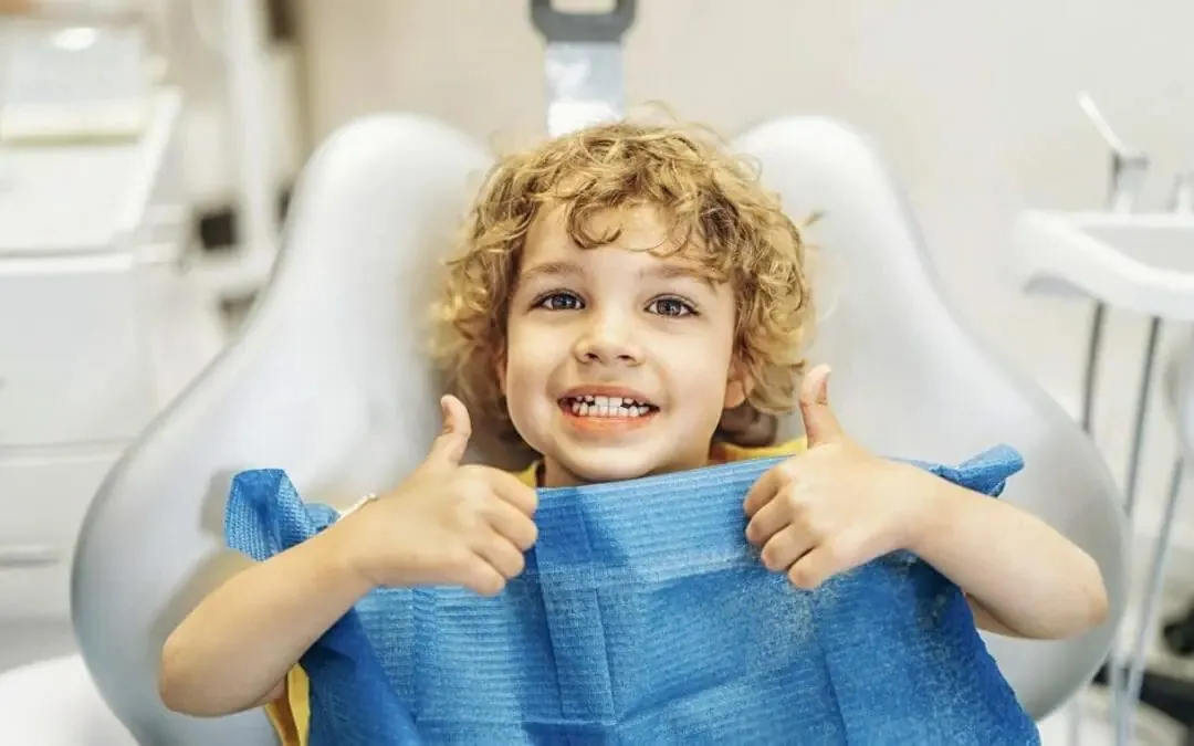 A happy child giving a thumbs up in the dental chair at Dentist In The Park, Bondi Junction