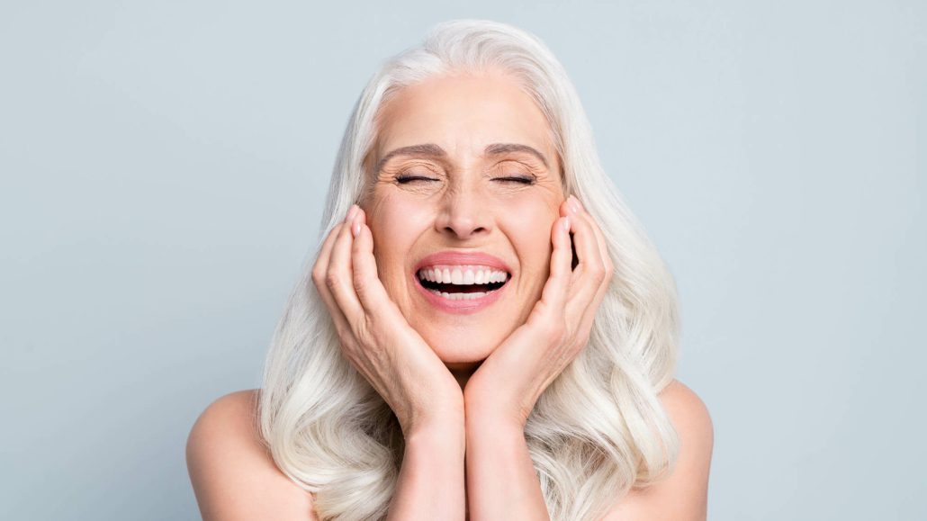 A smiling older woman with a healthy, confident smile